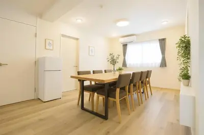 a kitchen and dining room with a table and chairs at SleepTokyo in Tokyo
