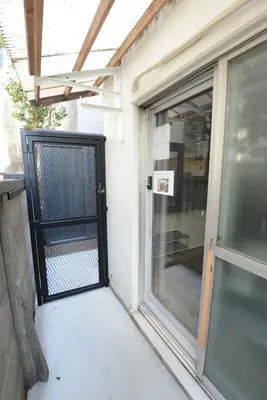 a black gate on a door of a house at SleepTokyo in Tokyo