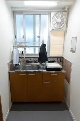 a kitchen with a sink and a window at SleepTokyo in Tokyo