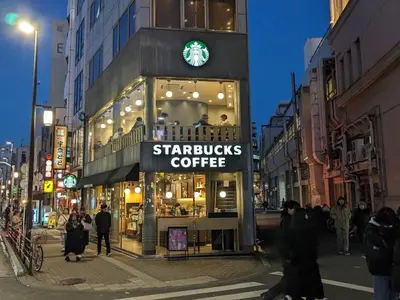 a starbucks coffee shop on a city street at night at \u30a8\u30d3\u30b9\u30d3\u30eb8\u968eStayCreek in Tokyo