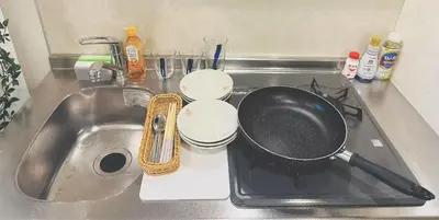 a frying pan sitting on top of a sink at Shinjuku city\u897f\u65b0\u5bbf in Tokyo