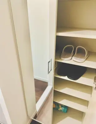 a closet with two pairs of shoes in it at Shinjuku city\u897f\u65b0\u5bbf in Tokyo