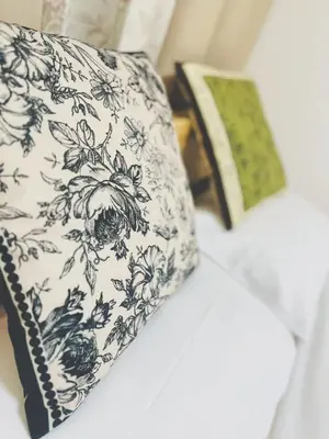a pillow with a floral pattern on it sitting on a bed at Shinjuku city\u897f\u65b0\u5bbf in Tokyo