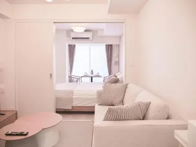 a white living room with a couch and a bed at Triphome Sugamo Otsuka 2025 New 7 mins 2 stations in Tokyo