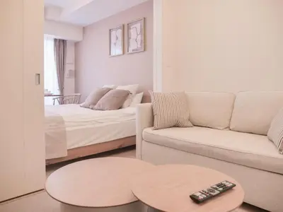a living room with a bed and a couch at Triphome Sugamo Otsuka 2025 New 7 mins 2 stations in Tokyo
