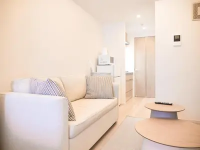 a living room with a white couch and a table at Triphome Sugamo Otsuka 2025 New 7 mins 2 stations in Tokyo