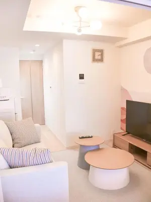 a living room with a couch and a table at Triphome Sugamo Otsuka 2025 New 7 mins 2 stations in Tokyo