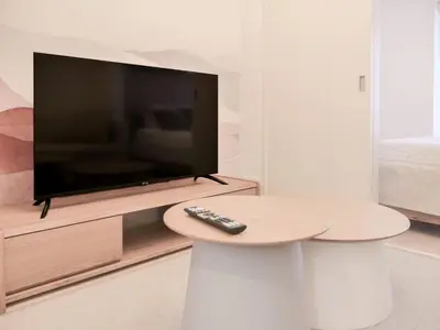 a remote control sitting on a table in front of a television at Triphome Sugamo Otsuka 2025 New 7 mins 2 stations in Tokyo