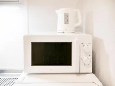 a white microwave with a blender on top of it at Triphome Sugamo Minami-Otsuka Studio in Tokyo