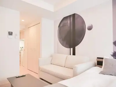a living room with a white couch and a table at Triphome Sugamo Minami-Otsuka Studio in Tokyo
