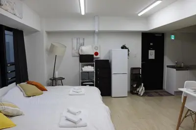 a room with two beds and a refrigerator at \u30d5\u30a7\u30a4\u30b9\u864e\u30ce\u95808\u968e in Tokyo