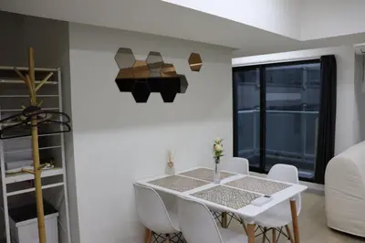 a dining room with a white table and chairs at \u30d5\u30a7\u30a4\u30b9\u864e\u30ce\u95808\u968e in Tokyo