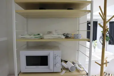 a microwave oven sitting on top of a shelf at \u30d5\u30a7\u30a4\u30b9\u864e\u30ce\u95808\u968e in Tokyo