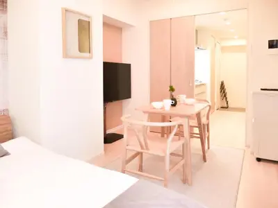 a room with a small table and two chairs at Triphome Otsuka Sugamo in Tokyo