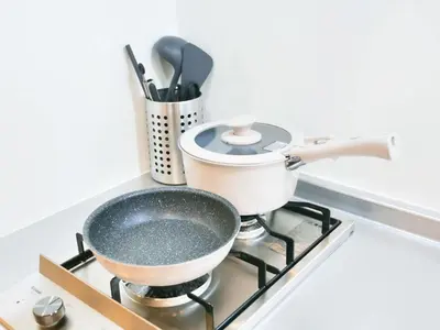 a pot on a stove with a pan on it at Triphome Otsuka Sugamo in Tokyo