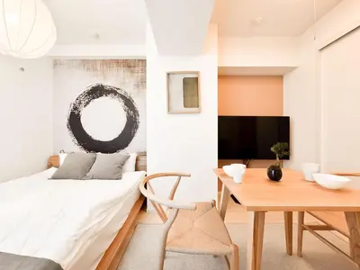 a living room with a bed and a table at Triphome Otsuka Sugamo in Tokyo