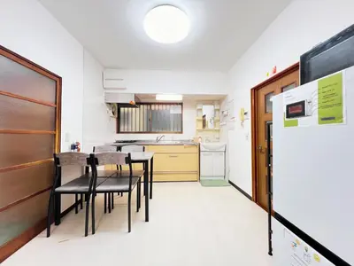 a kitchen with tables and chairs in a room at Tokyo Nukumori Lodge in Tokyo
