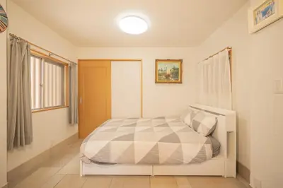 a bedroom with a bed in a room with a window at Ryokan ○ - Vacation STAY 01019v in Tokyo