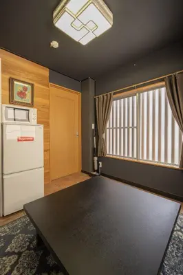a room with a table and a refrigerator and a window at Ryokan ○ - Vacation STAY 01019v in Tokyo