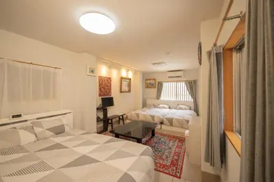 a hotel room with two beds and a table at Ryokan ○ - Vacation STAY 01019v in Tokyo