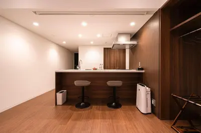 a kitchen with a counter and stools in a room at Cava House - Vacation STAY 07286v in Tokyo