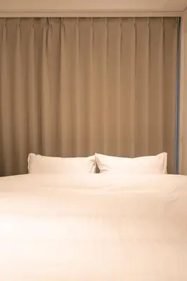 two white beds in a bedroom with a curtain at Cava House - Vacation STAY 07286v in Tokyo