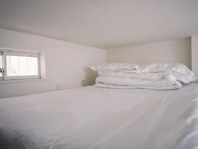 a white bed with white sheets and pillows at D Regalo - Vacation STAY 10830v in Tokyo