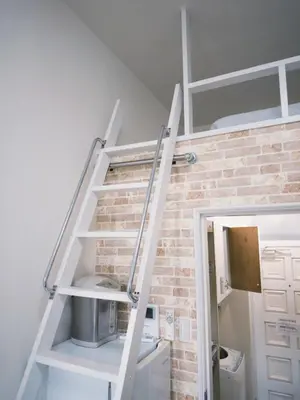 a staircase in a room with a brick wall at D Regalo - Vacation STAY 10830v in Tokyo