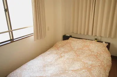 a bedroom with a bed with a white bedspread and a window at Takaoka Building - Vacation STAY 10286v in Tokyo