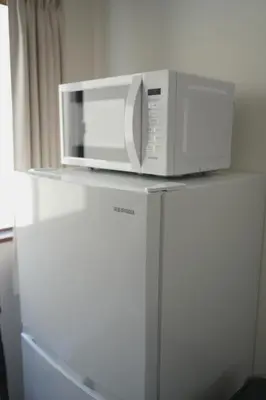 a microwave sitting on top of a refrigerator at Takaoka Building - Vacation STAY 10286v in Tokyo