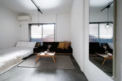a living room with a couch and a table at Eden House - Vacation STAY 19890 in Tokyo