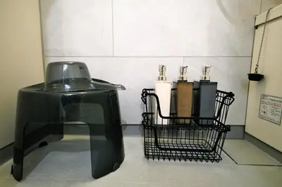 a black chair and a basket with three candles at Eden House - Vacation STAY 19890 in Tokyo