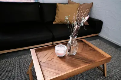 a coffee table with a vase of flowers and a candle at Eden House - Vacation STAY 19890 in Tokyo