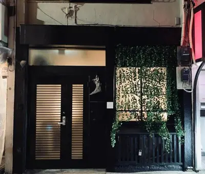 a building with a black door and a window at Eden House - Vacation STAY 19890 in Tokyo