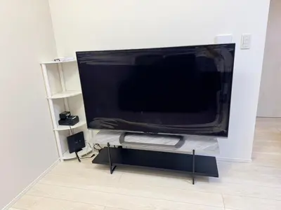a large flat screen tv sitting on a stand in a room at Nerima-ku - House - Vacation STAY 19929 in Tokyo