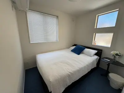 a small bedroom with a bed and two windows at Nerima-ku - House - Vacation STAY 19929 in Tokyo