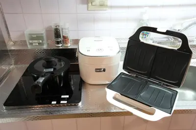 a kitchen counter with a toaster and a coffee maker at Shinjuku Camellia Nest in Tokyo