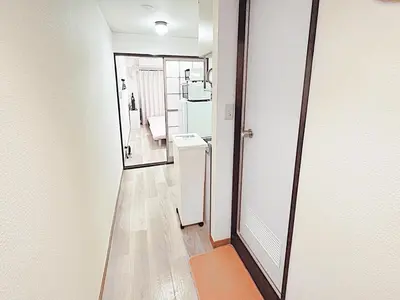 a hallway with two mirrors and an orange rug at Tokyo Stay West Sugamo #104 in Tokyo