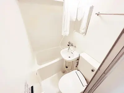 a white bathroom with a toilet and a sink at Tokyo Stay West Sugamo #104 in Tokyo