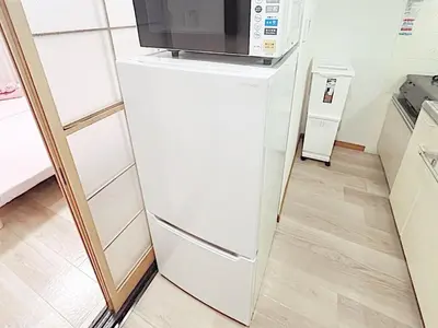 a white refrigerator with a microwave on top of it at Tokyo Stay West Sugamo #104 in Tokyo