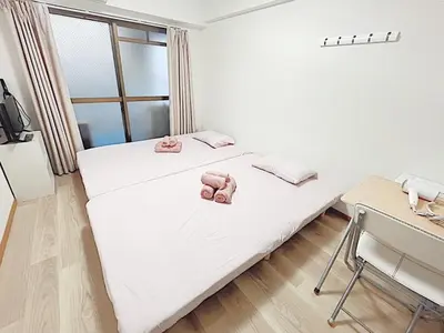 a bedroom with two pink stuffed animals on a bed at Tokyo Stay West Sugamo #105 in Tokyo