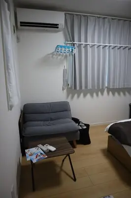 a living room with a couch and a table at Tateishi House101 in Tokyo