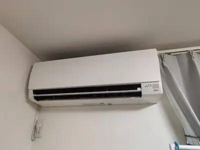 a white air conditioner on a wall in a room at Tateishi House101 in Tokyo