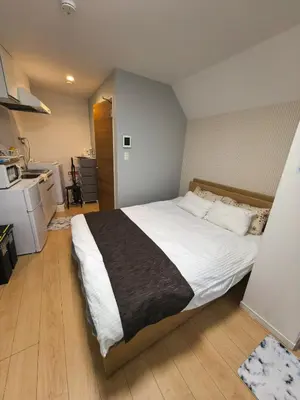 a bedroom with a large bed in a room at Tateishi House101 in Tokyo