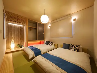 two beds in a room with a window at Yadoya Asakusa Asagao in Tokyo