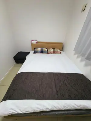 a bedroom with a bed with a brown blanket at Tateishi House201 in Tokyo