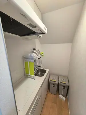 a small kitchen with a sink and two trash cans at Tateishi House201 in Tokyo