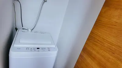 a washing machine with a cord attached to a wall at Tateishi House201 in Tokyo