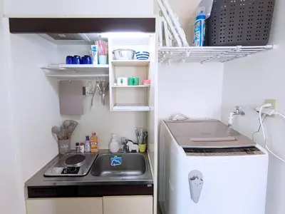 a small kitchen with a sink and a refrigerator at Yoyogi 10min Walk Shinjuku&Shibuya 3bed in Tokyo