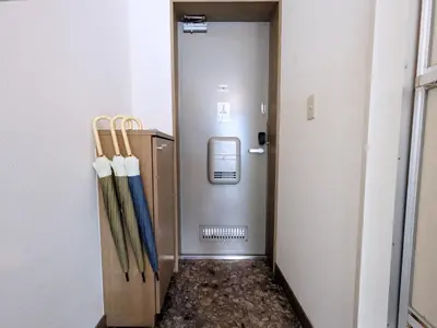 a hallway with two baseball bats and a door at Yoyogi 10min Walk Shinjuku&Shibuya 3bed in Tokyo